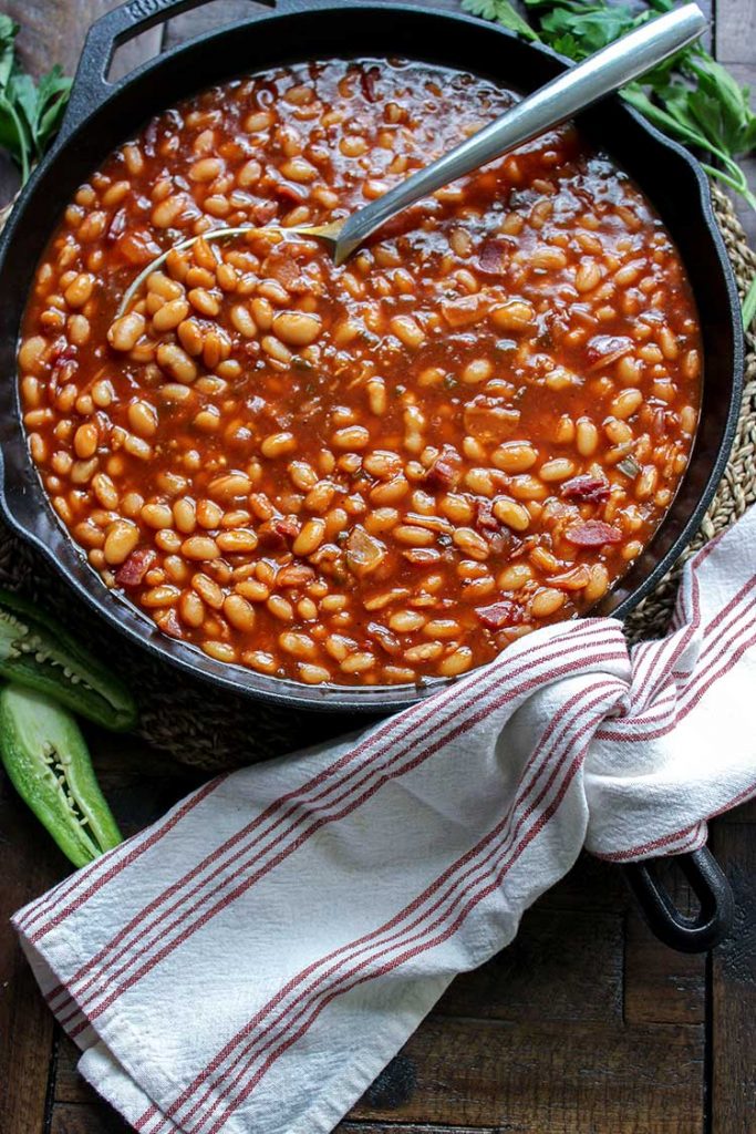 smoked baked beans with spoon in pot 