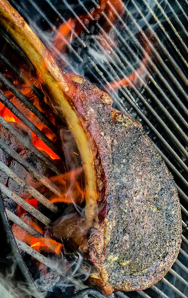 Searing a steak over high heat for Maillard reaction