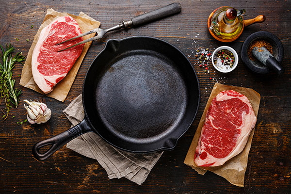 Cast iron skillet, steak and seasonings for Translating Grill Favorites for Indoor Cooking