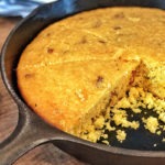 cheddar jalapeño cornbread sliced in cast iron pan