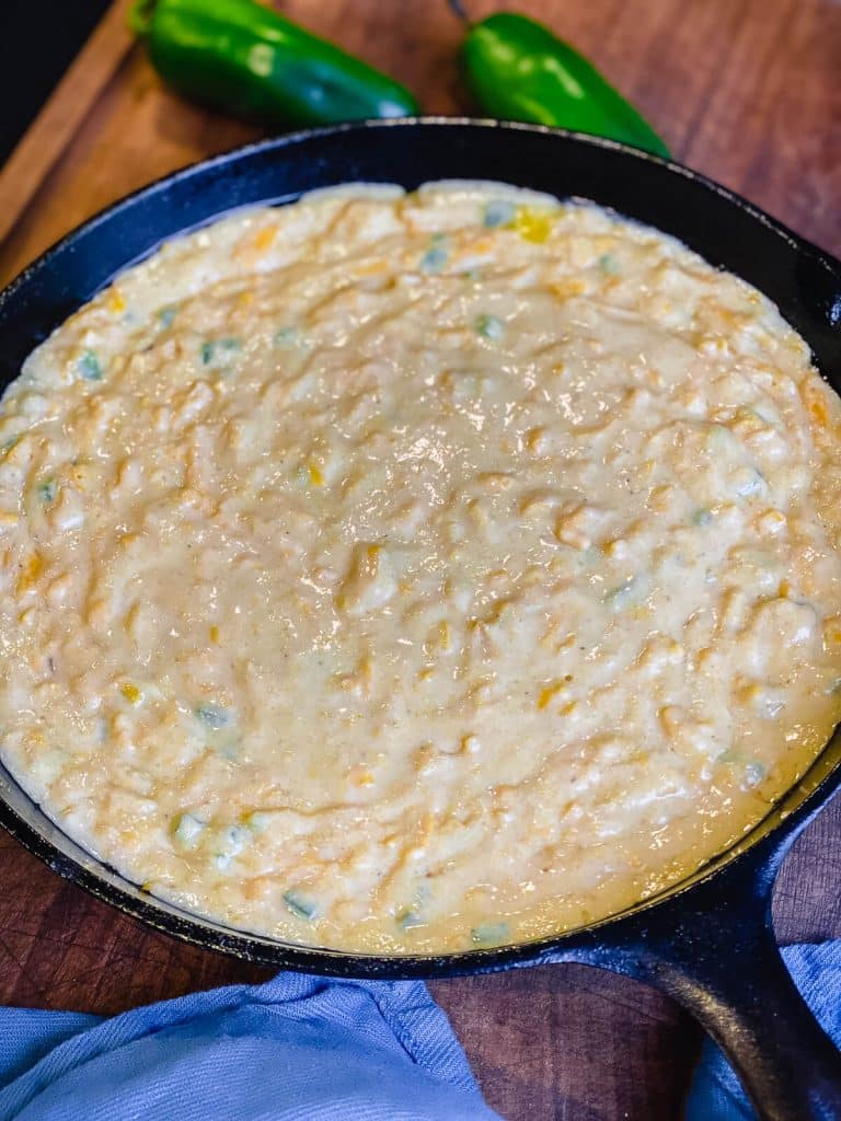 cornbread uncooked in cast iron skillet