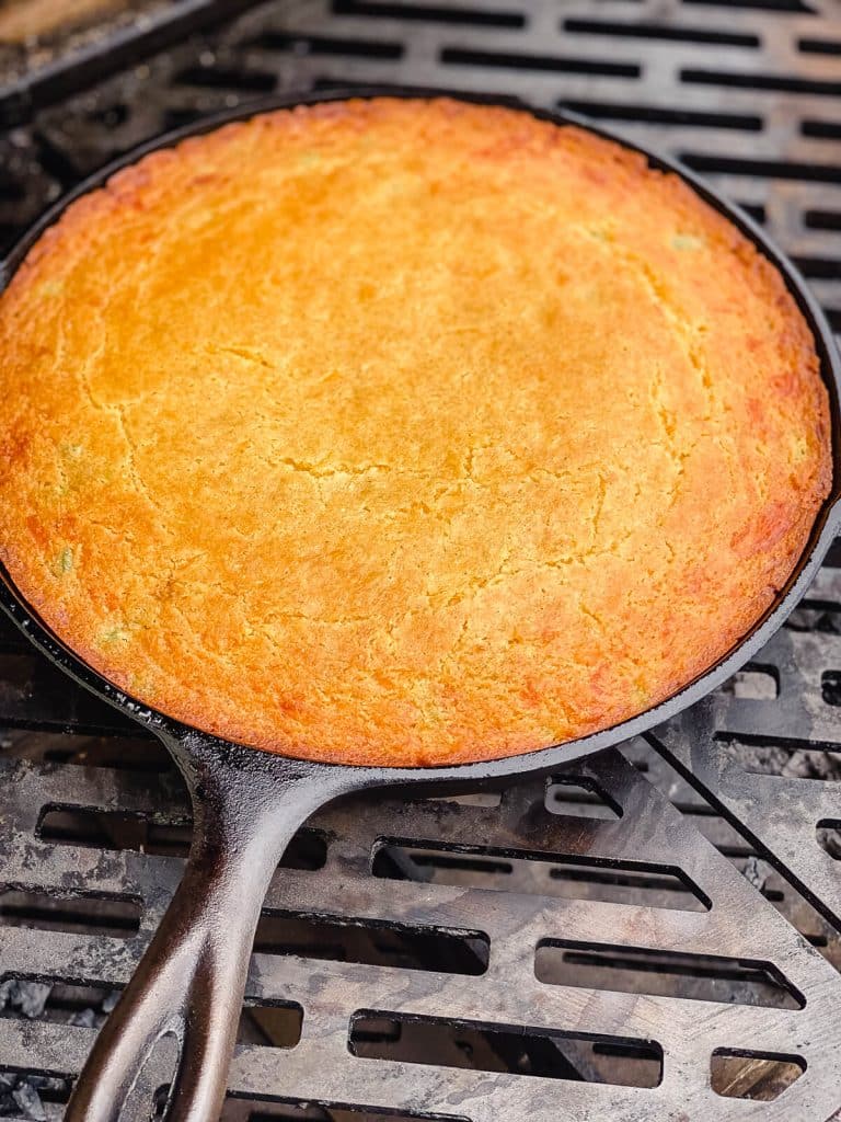cornbread in a cast iron pan on a grill