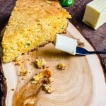 slice of cheddar jalapeno cornbread with butter