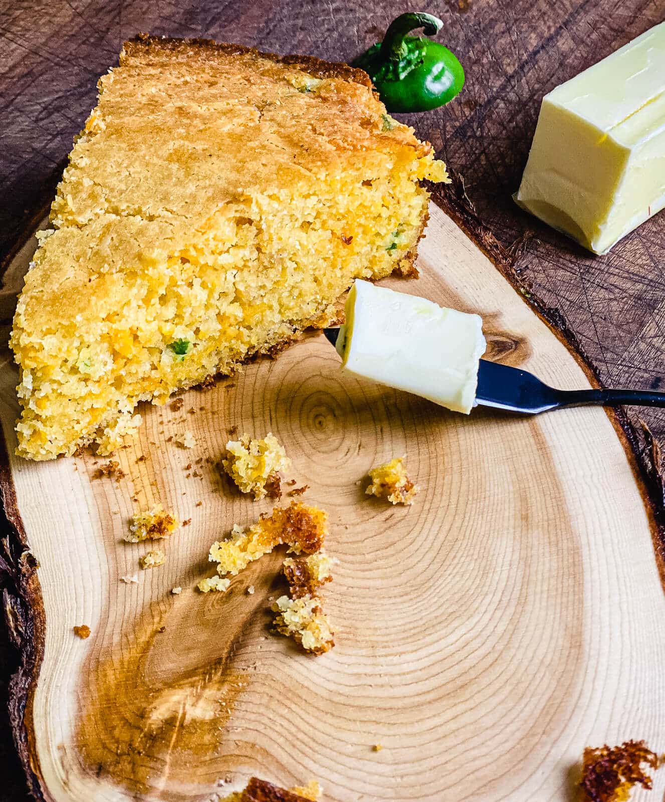 slice of cheddar jalapeno cornbread with butter