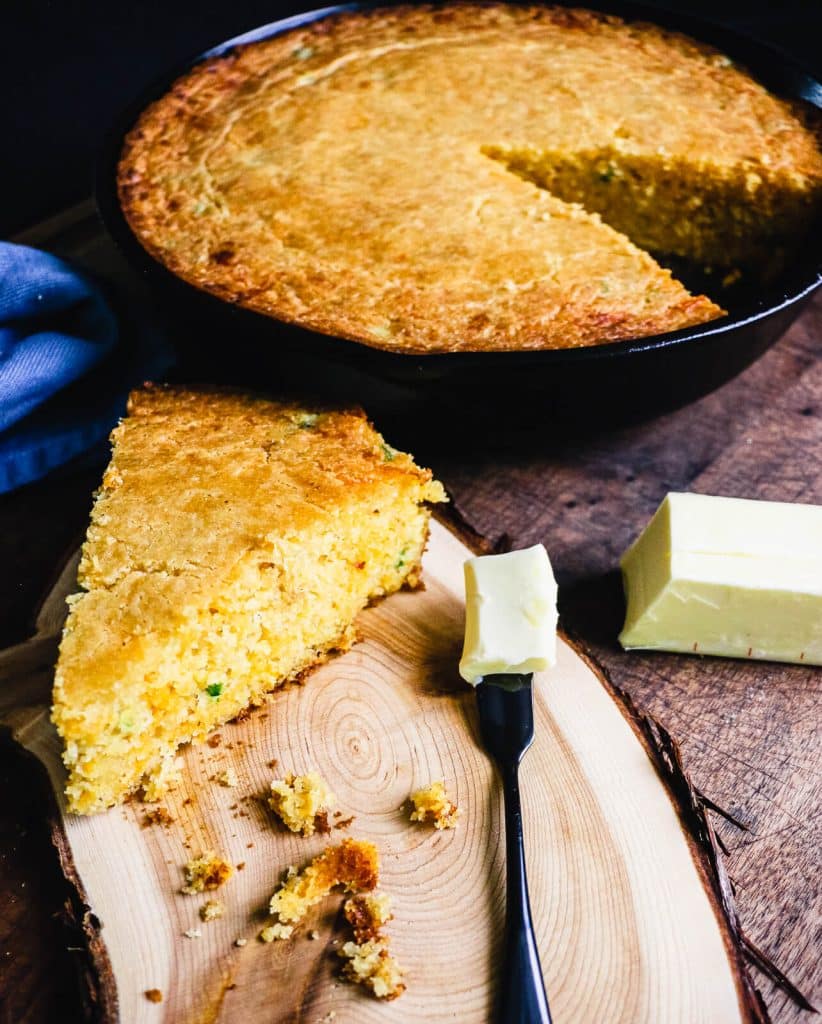 slice of cheddar jalapeno cornbread with butter