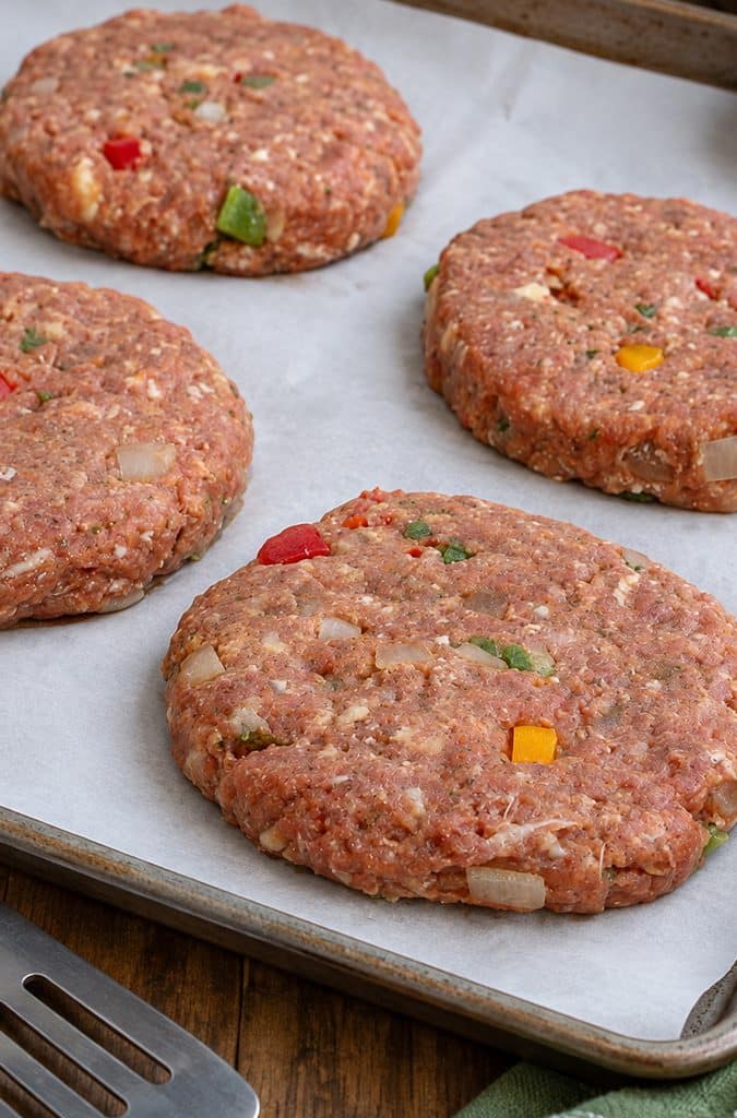 meatloaf burgers formed into patties and placed in a parchment lined cooking sheet