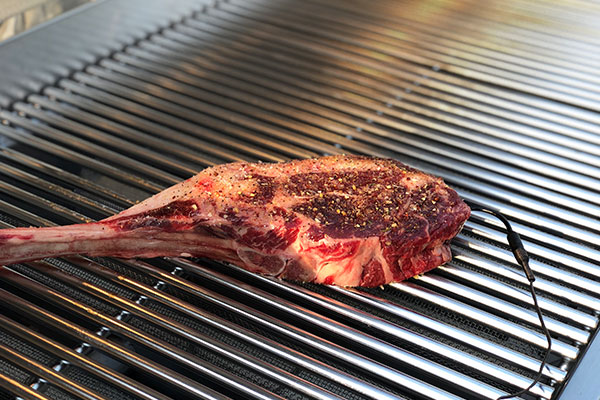 Tomahawk steak on grill 