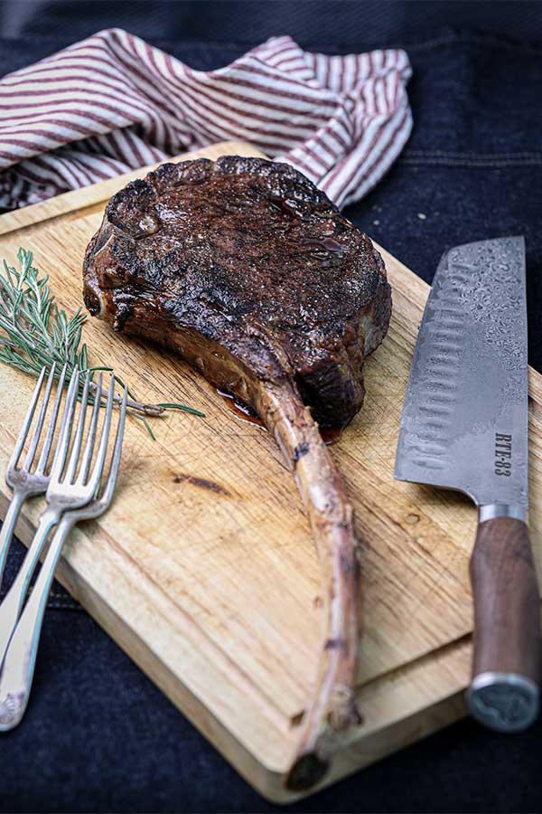 perfectly seared tomahawk steak resting before serving