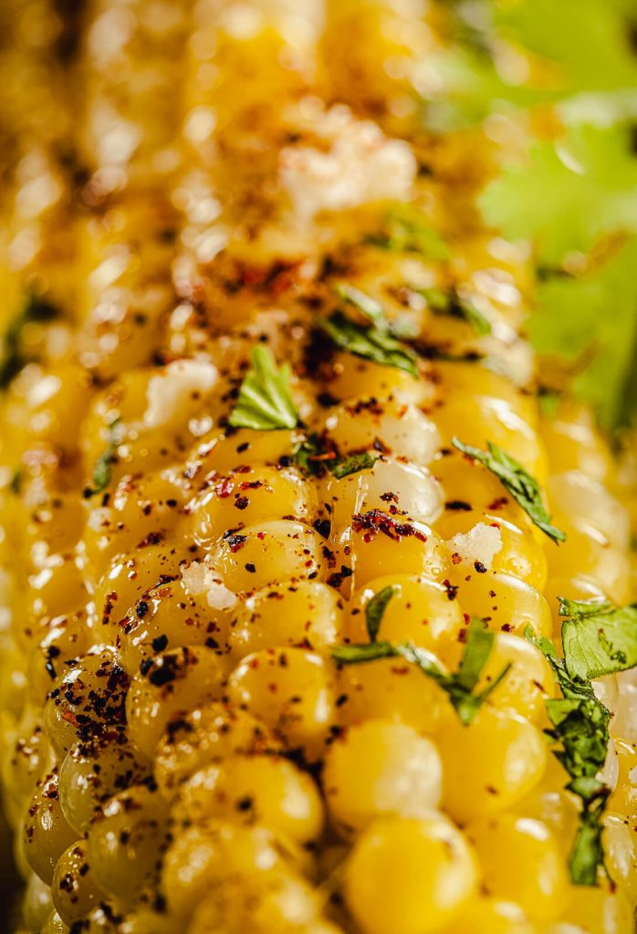 close up of an ear of grilled Mexican street corn