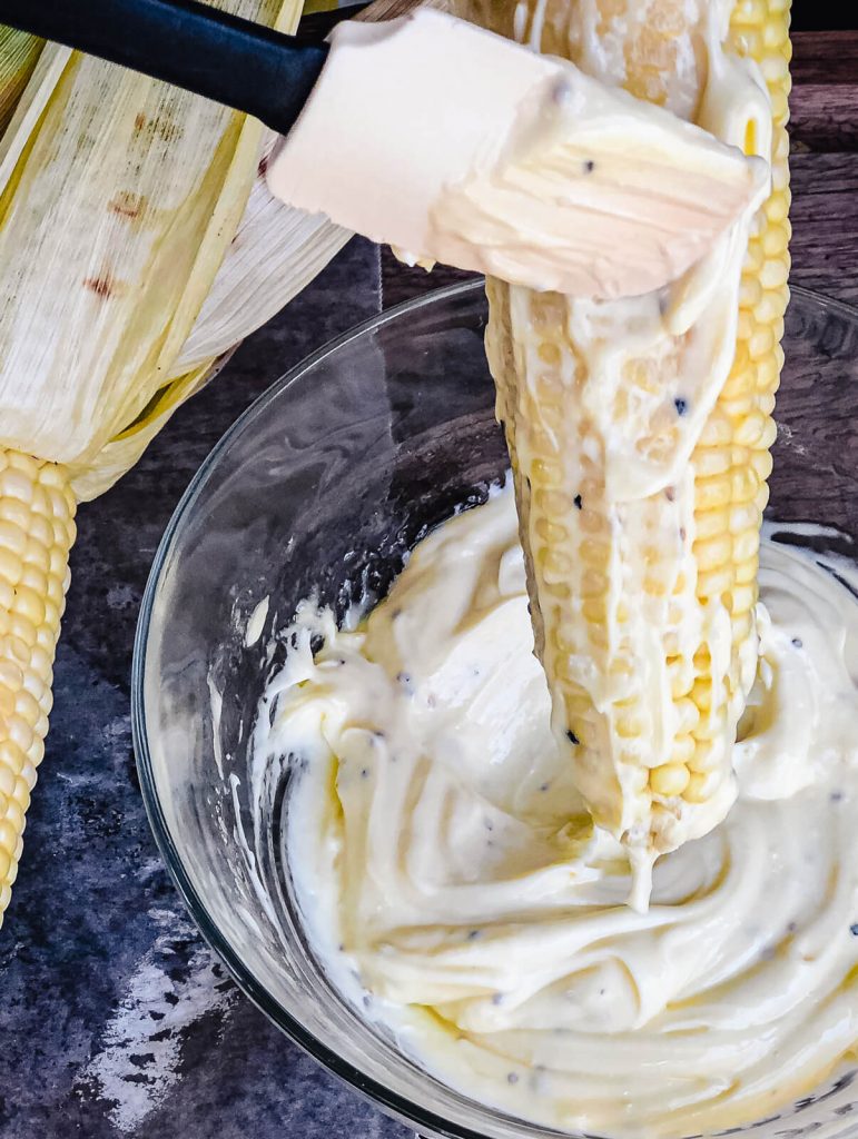 mayo being applied to Mexican street corn
