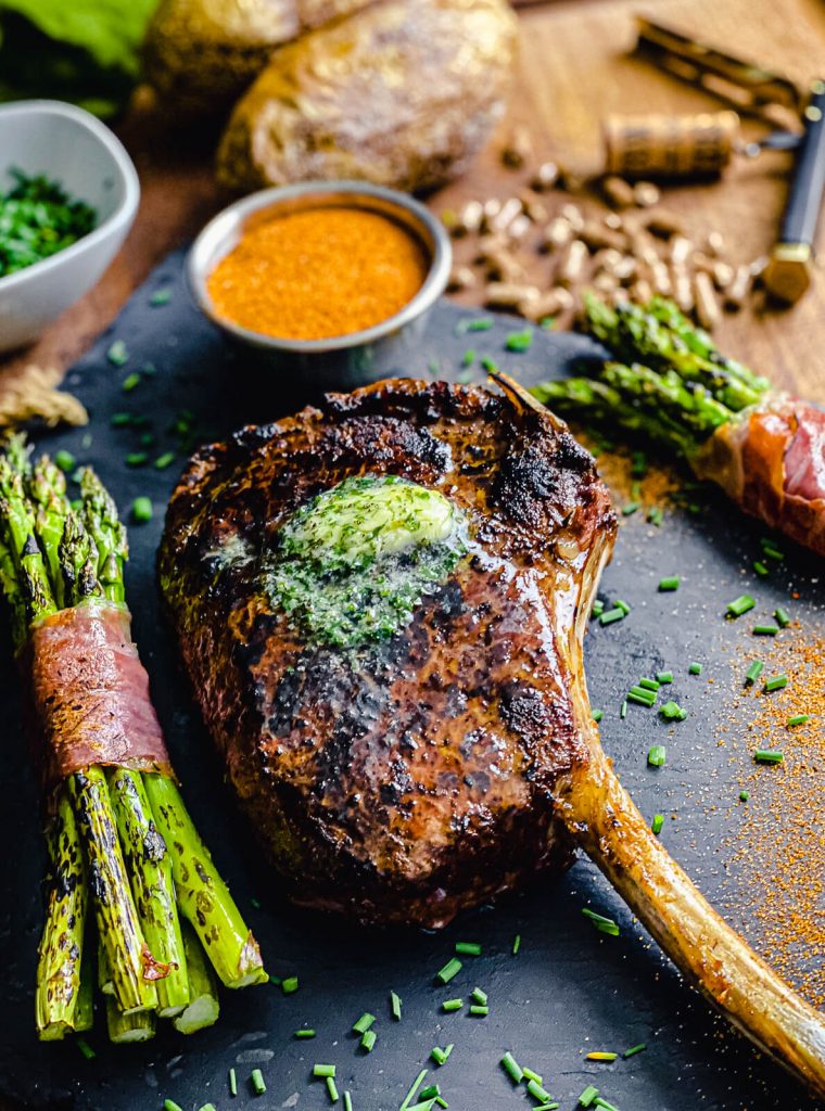 seared tomahawk ribeye on slate platter