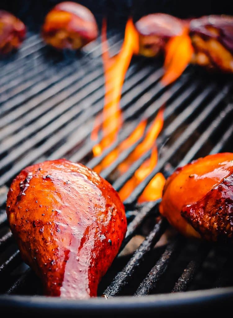 smoked chicken legs over indirect heat on a charcoal grill