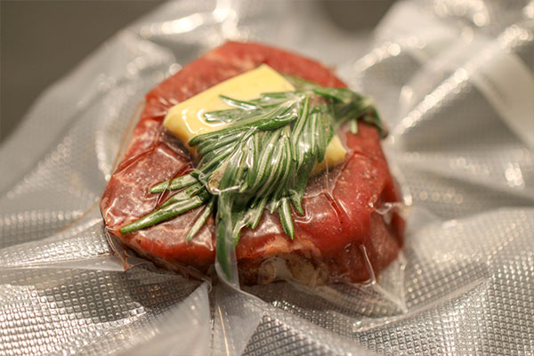 sous vide filet mignon in package with butter and seasoning