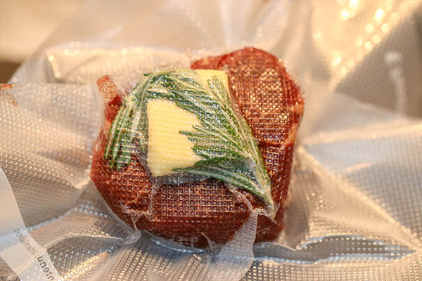 raw sous vide filet mignon with rosemary and butter