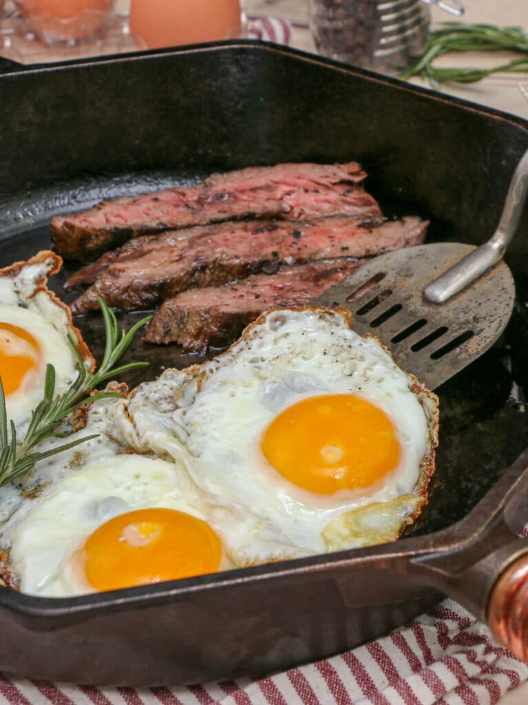 steak and eggs in a cast iron skillet