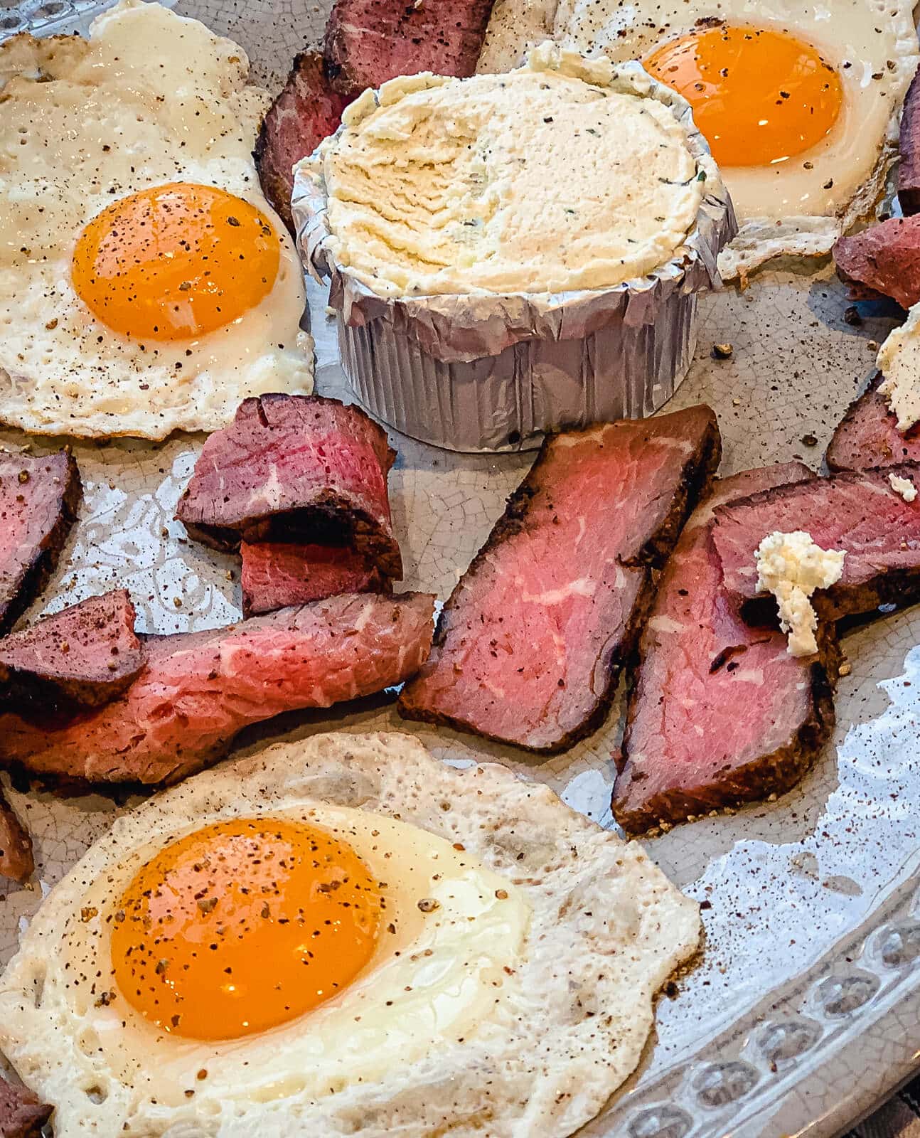 steak and eggs on a platter