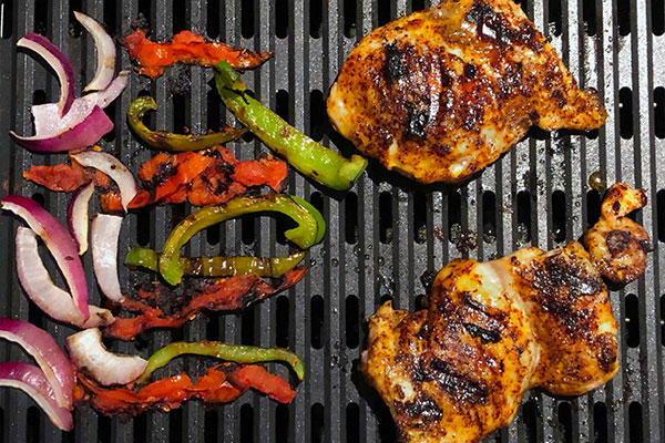 Chicken and vegetables grilled on the Chefman Electric Grill indoors