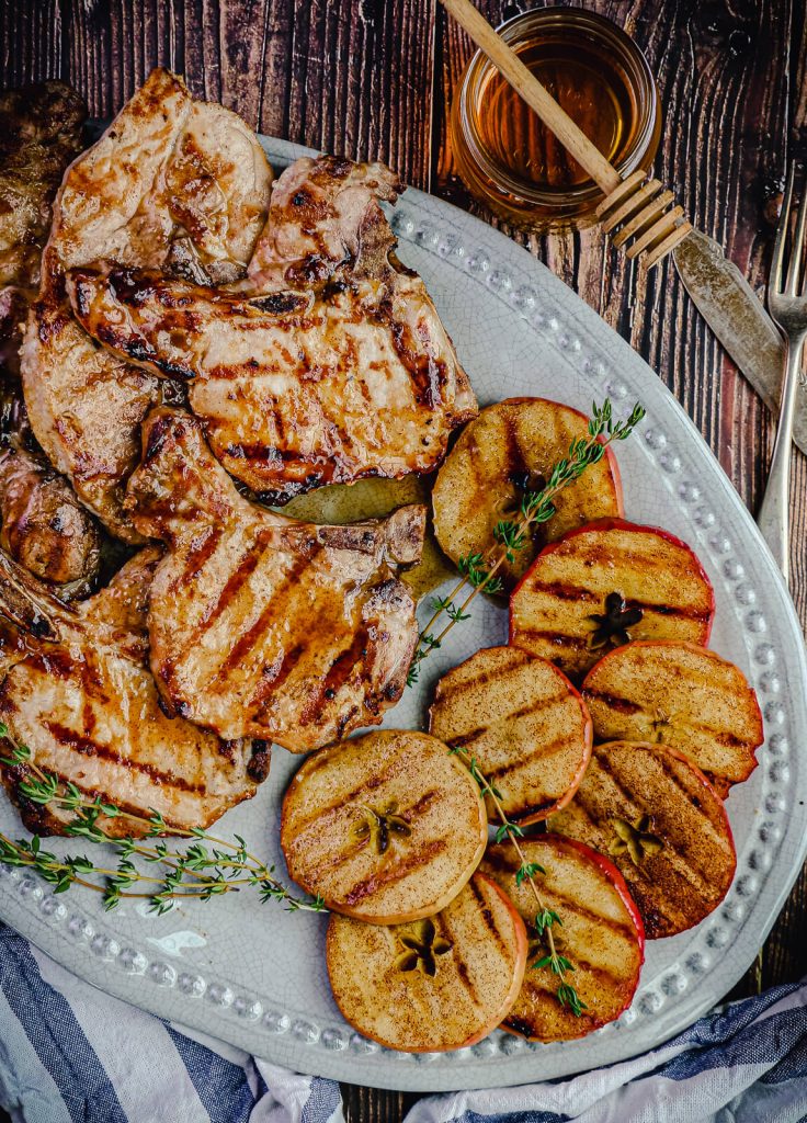 galzed grilled pork chops and apples on a platter