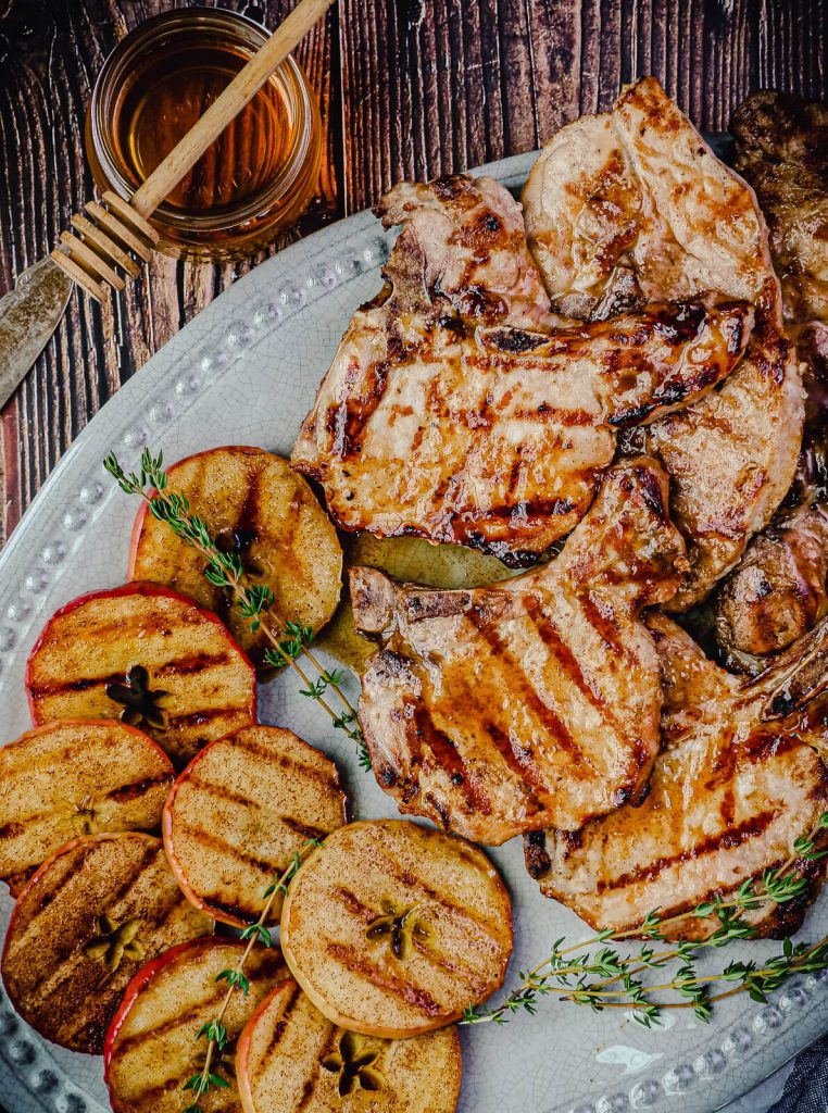 platter of grilled pork chops and grilled apples