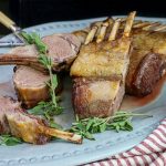 Rotisserie Rosemary Crusted Lamb sliced and served on a platter