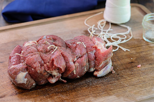 Preparing the boneless leg of lamb to tie with butcher's twine for the Rotisserie Boneless Leg of Lamb recipe