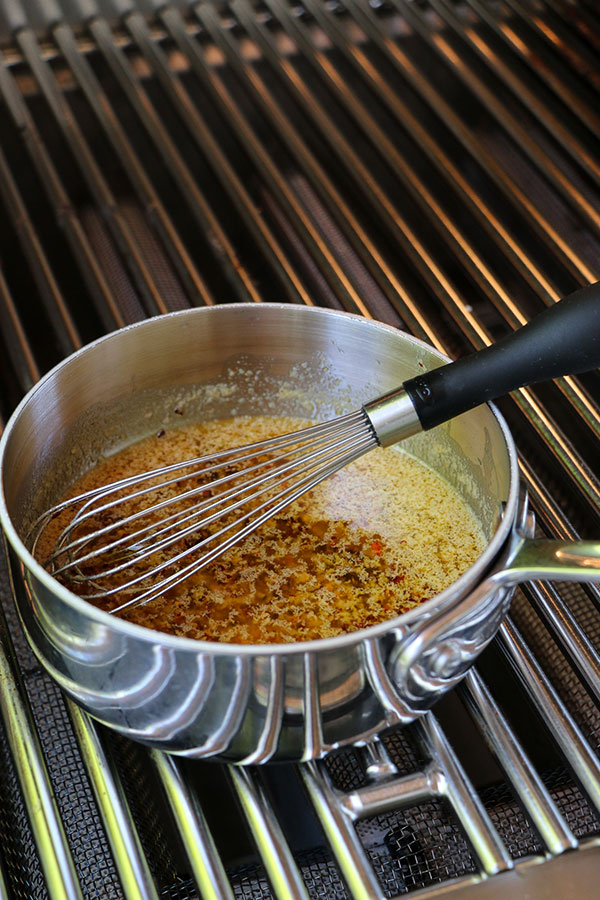 butter, garlic, ginger, olive oil and red pepper flakes simmering in a saucepan