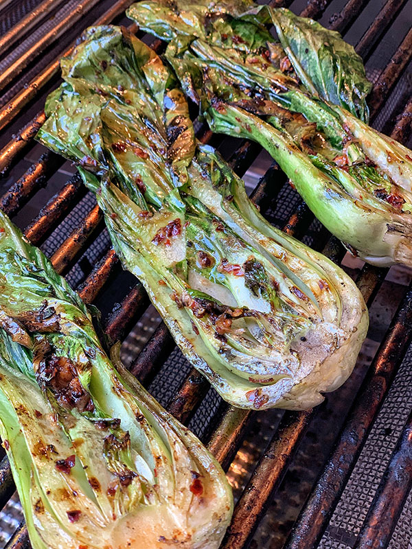 Spicy Grilled Baby Bok Choy cooking on high heat