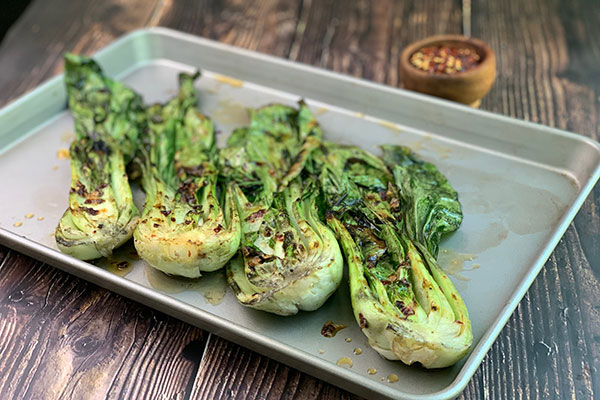 Spicy Grilled Baby Bok Choy with additional red pepper flakes for sprinkling