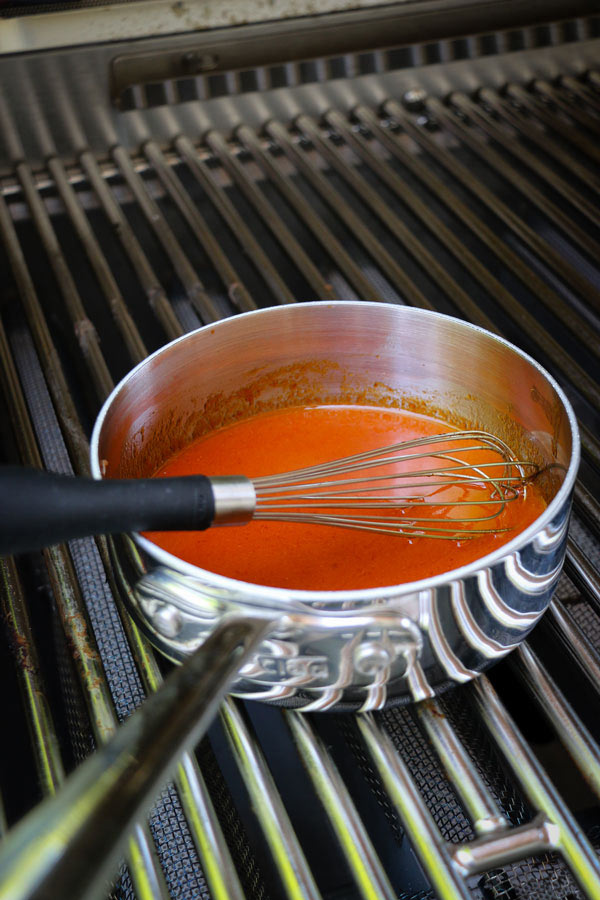 sriracha, soy, honey, ginger and garlic melding in a pot for Grilled Honey Sriracha Chicken Thighs Recipe