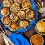 pan seared scallops with bayou butter on a blue plate