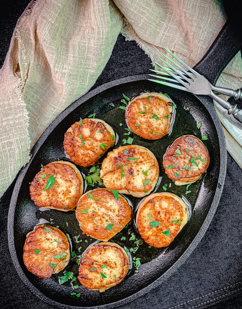 scallops on a cast iron serving tray