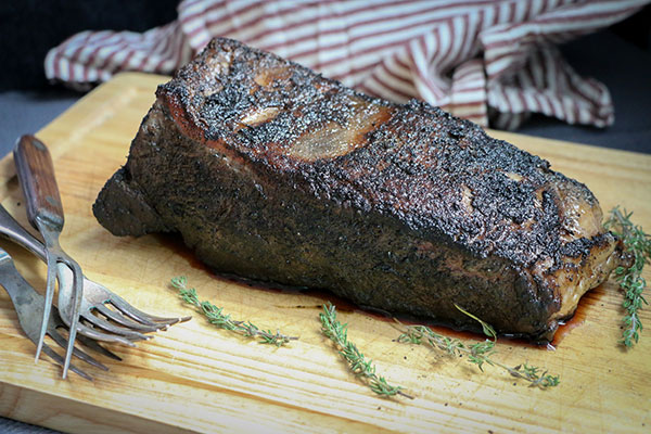 Sous vide NY strip steak with compound herb butter resting before slicing