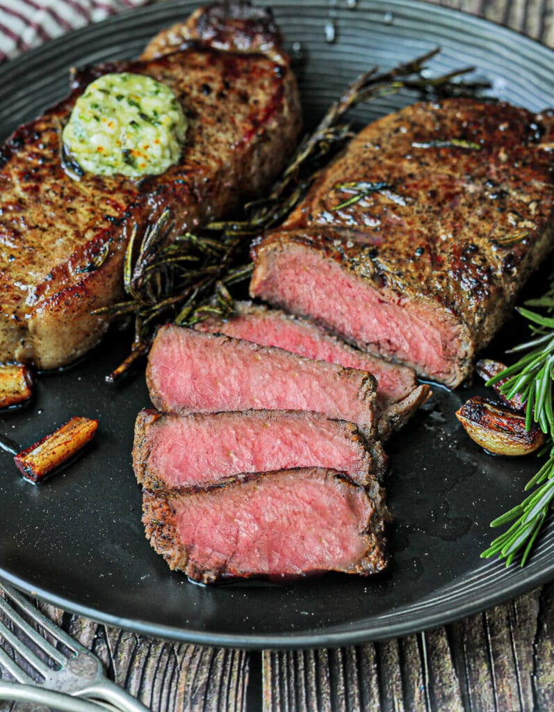 sliced strip steaks topped with compound butter