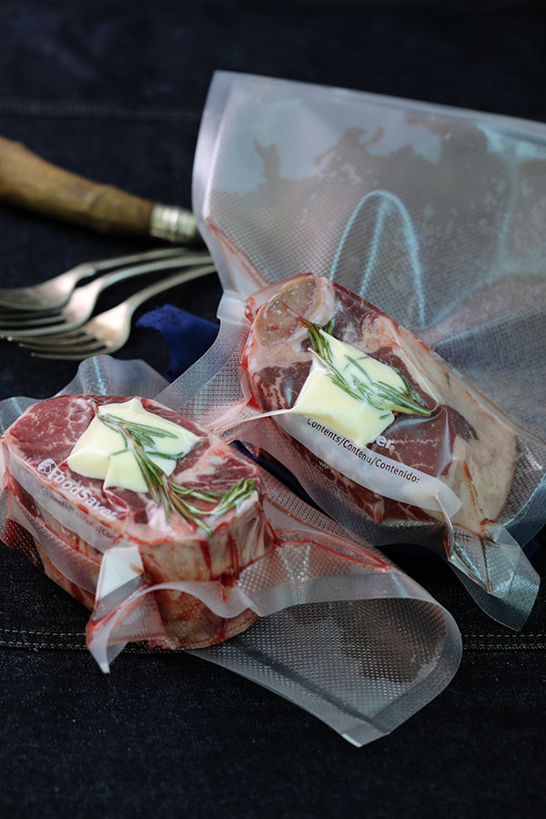 Bone in filet mignon sealed in vacuum bags and ready for sous vide bath