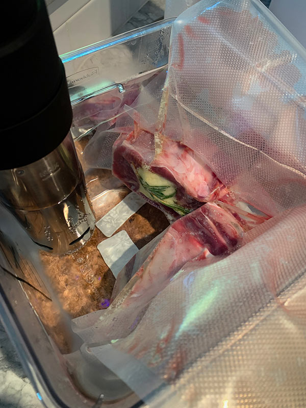 Bone in filet mignon cooking in sous vide bath