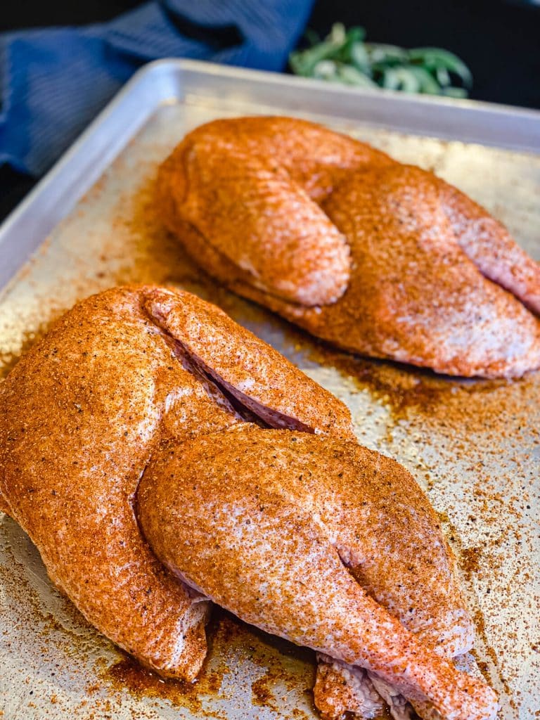 seasoned turkey halves on a platter
