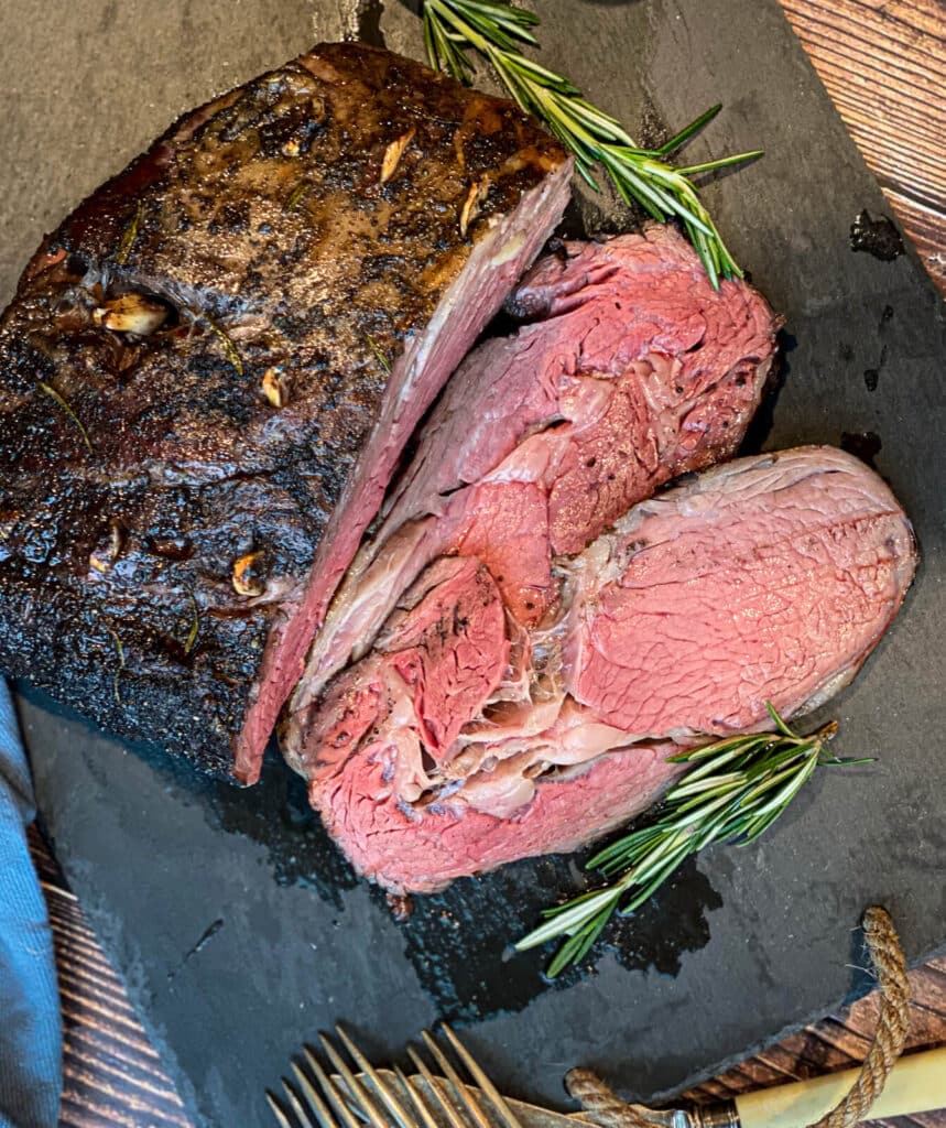 sliced smoked prime rib recipe on a cutting board