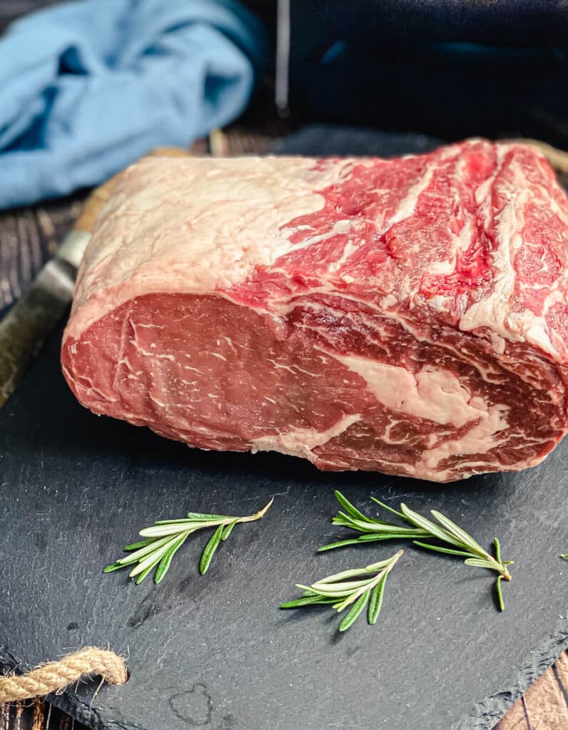 uncooked prime rib with rosemary