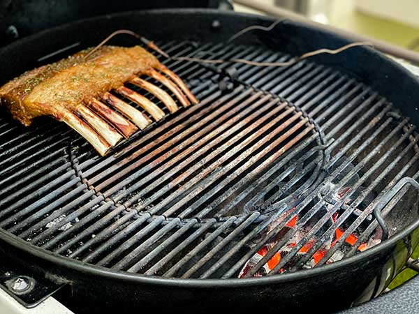 rack of lamb on the grill with meat thermometer hooked up.