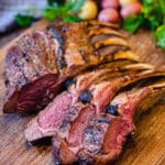 grilled lamb chops sliced on a cutting board