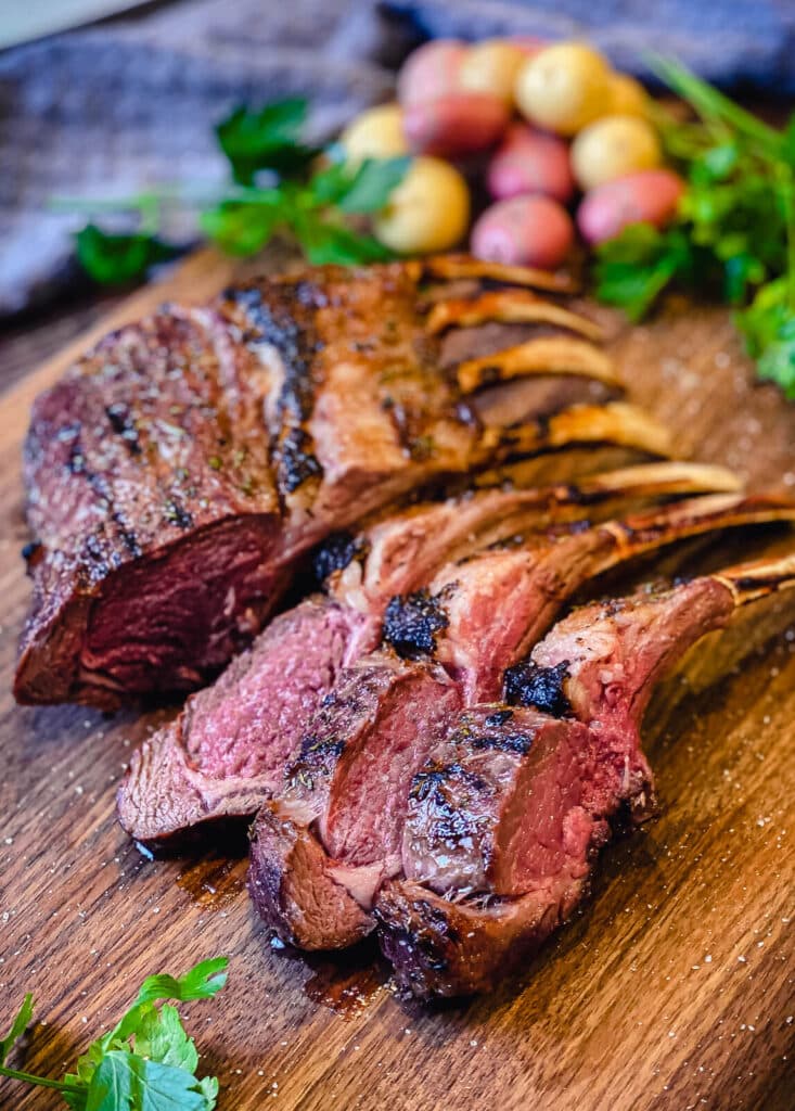grilled lamb chops sliced on a cutting board