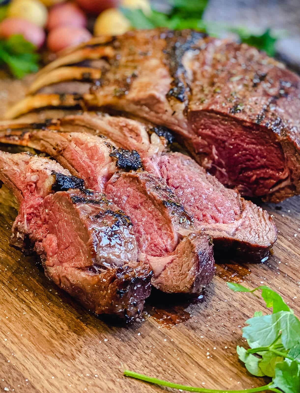 rack of lamb sliced on a cutting board