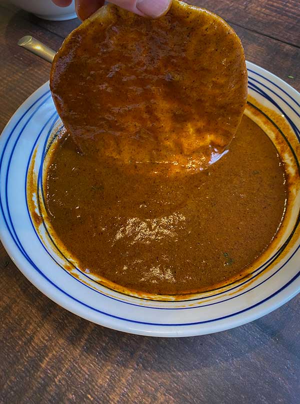 corn tortilla dipped in homemade enchilada sauce