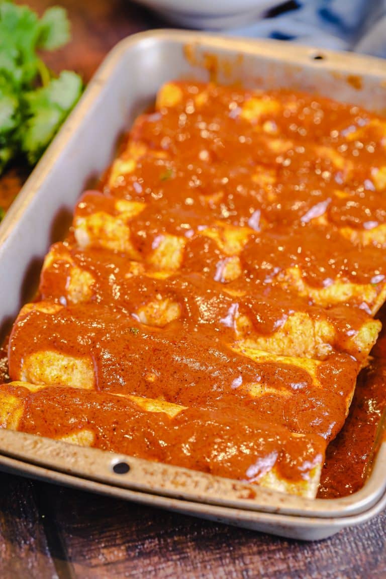 homemade enchilada sauce on a tray of enchiladas