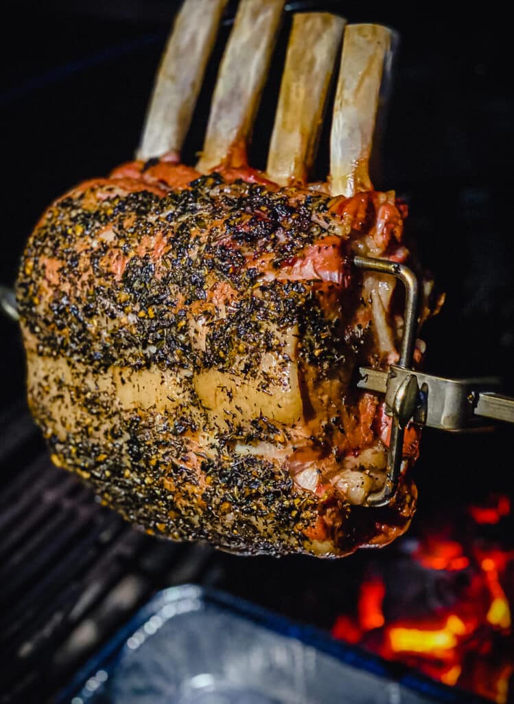 rack of veal on a rotisserie over hot coals