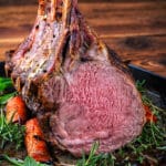 herb crusted rack of veal on a platter of herbs