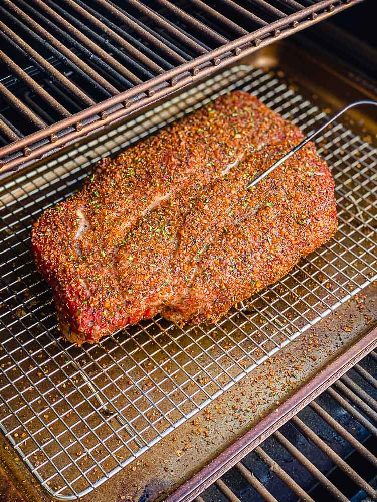 chuck roast smoking on a grill