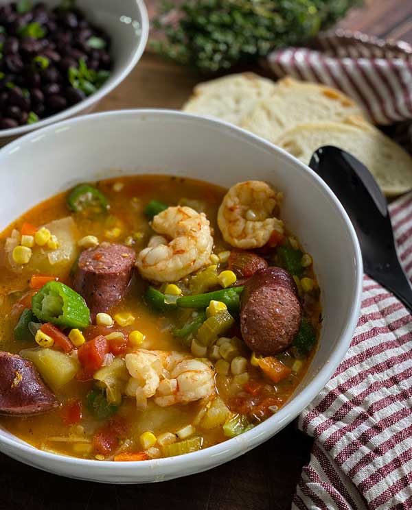 Spicy low country boil served with bread and greens