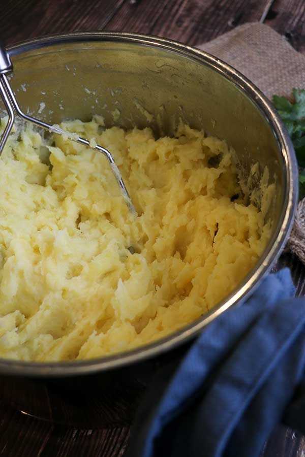 Mashing potatoes with roasted garlic butter