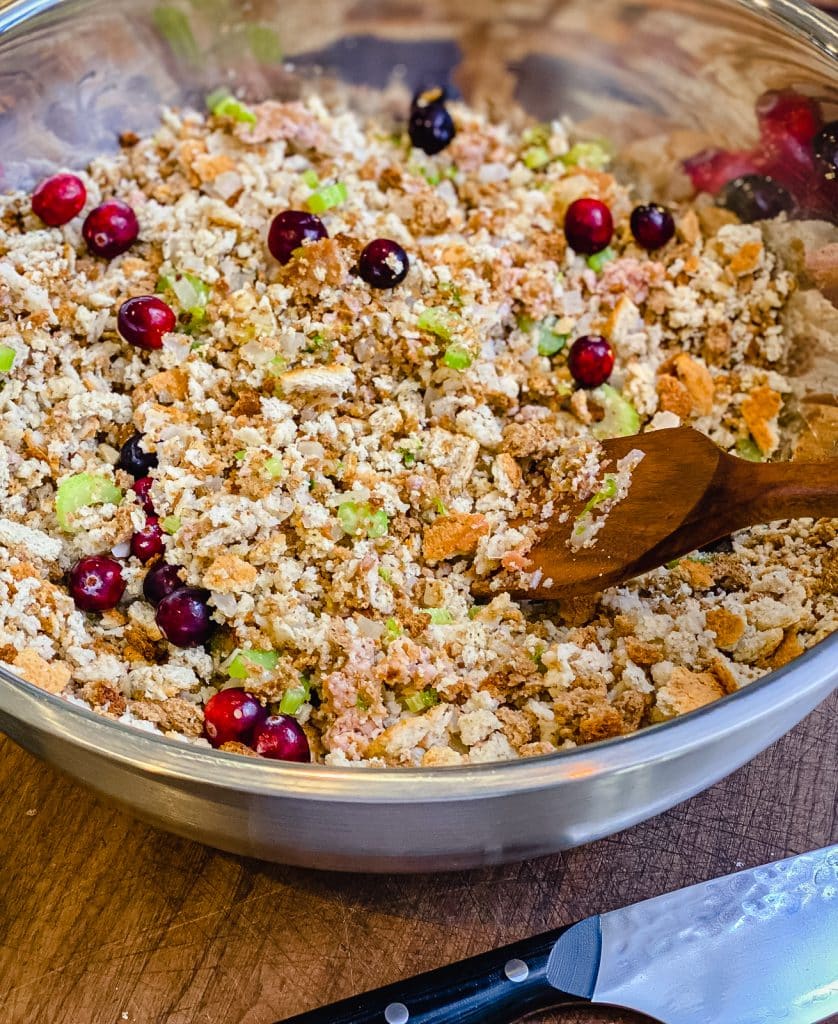 mixing together thanksgiving dressing ingredients in a large bowl